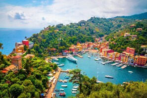 A coastal town with colorful buildings, a marina with boats, and lush greenery. - Cozy Maria Apartment in Portofino (Portofino)