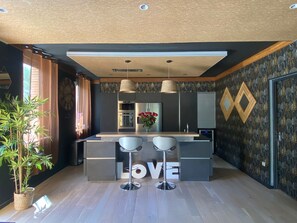 Enjoy cooking in this stylish kitchen with a central island and ample counter space.