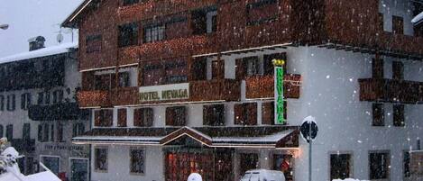 A hotel with multiple floors, a prominent sign reading "HOTEL NEVADA," and a snow-covered exterior.