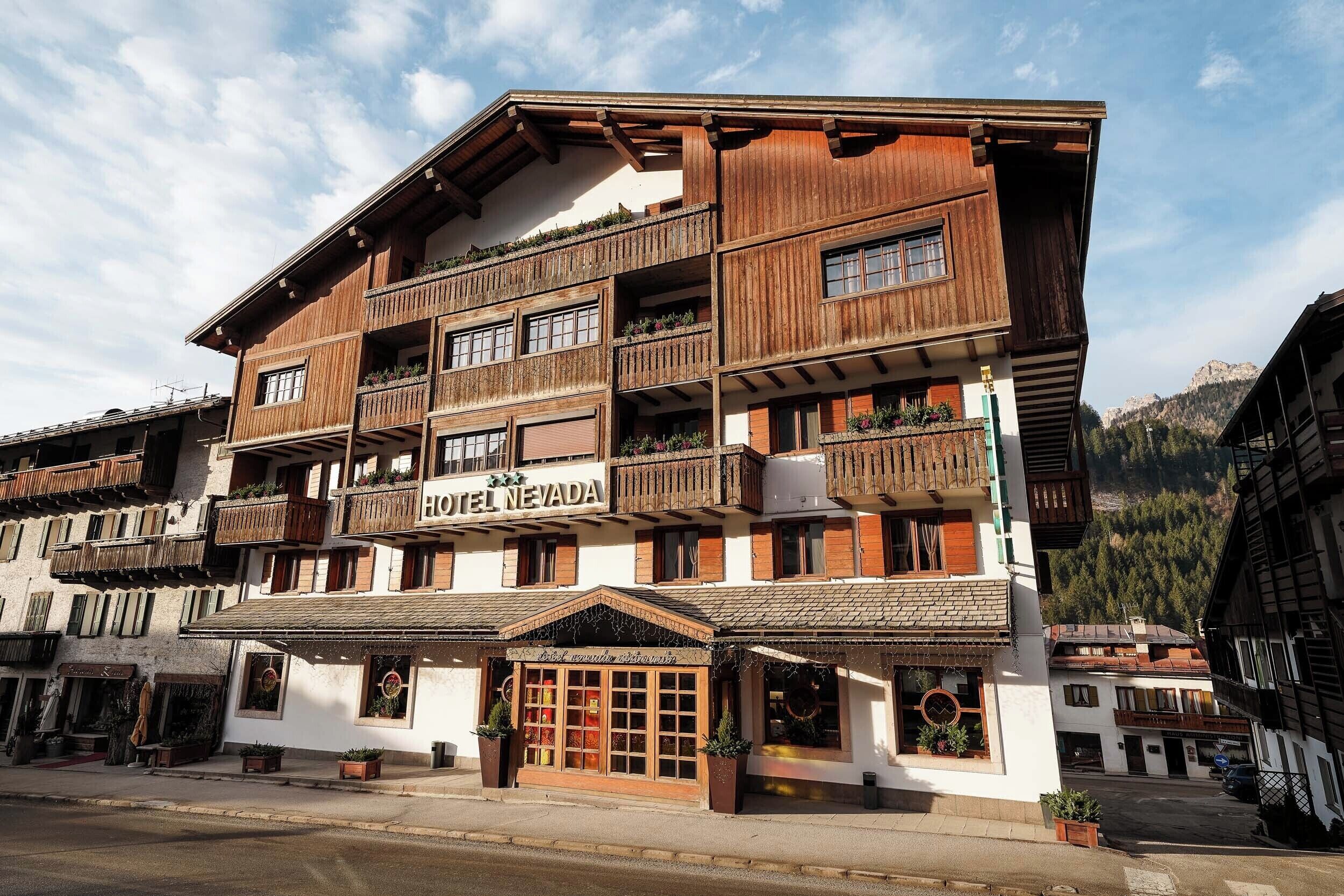 A multi-story hotel with wooden balconies and a sign reading "HOTEL NEVADA".