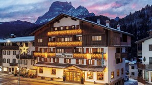 A multi-story hotel with a prominent sign reading "HOTEL NEVADA." - Best Western Hotel Nevada (San Vito di Cadore)