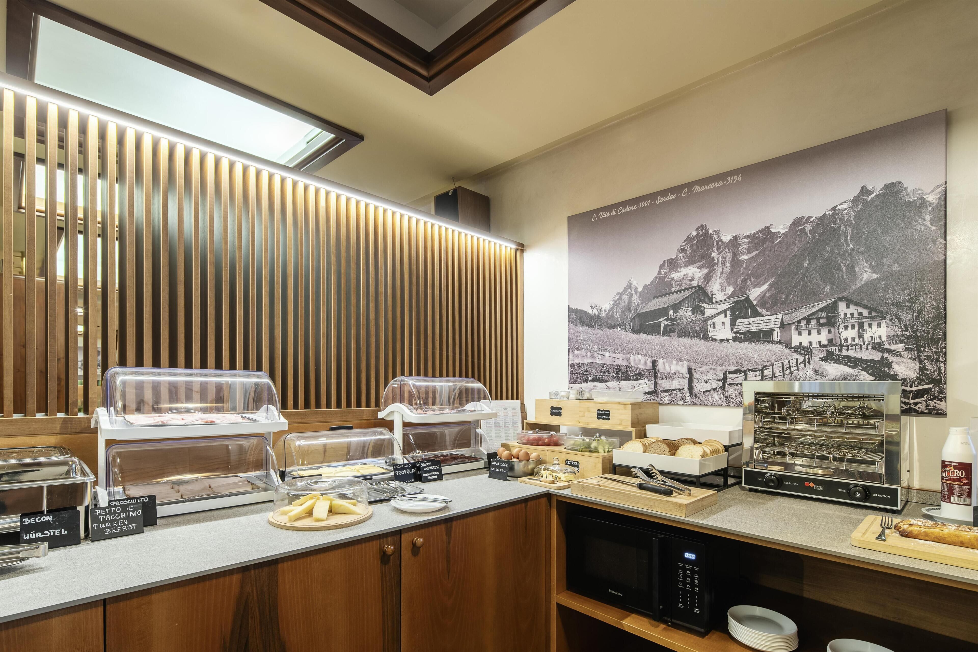 A breakfast bar with various food items and a coffee machine.