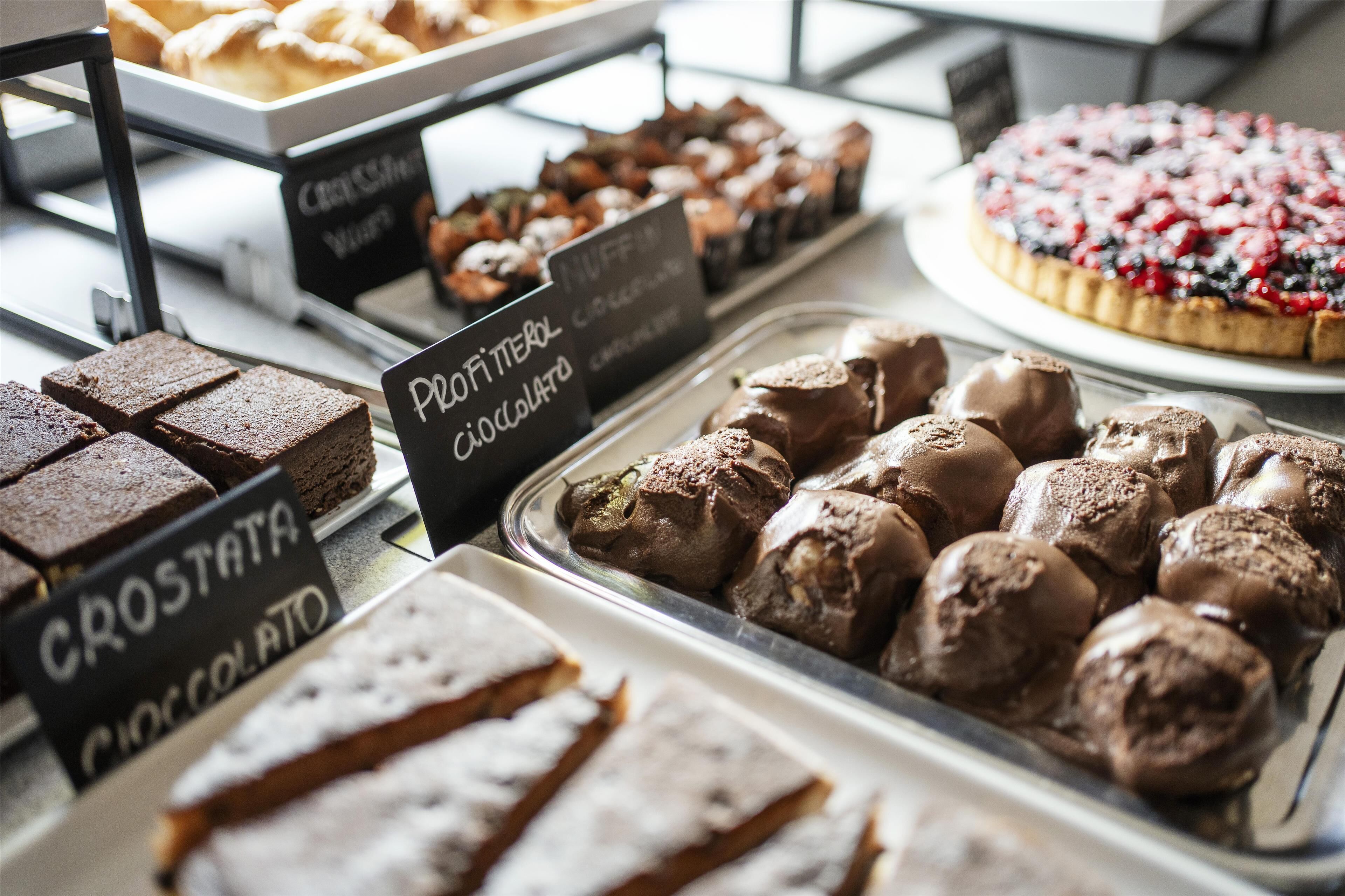 A bakery display with various chocolate desserts.