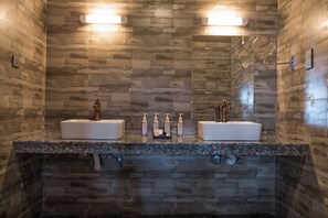 A modern bathroom with two sinks, wooden wall tiles, and overhead lighting. - Nokras Enkare Luxury Tented Camp Sagana (Sagana)