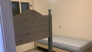 A bedroom with a bunk bed and a single bed.