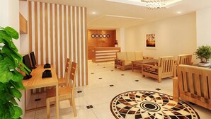 A modern hotel lobby with a reception desk, seating area, and a decorative chandelier. - Siren Flower Hotel (Nha Trang)