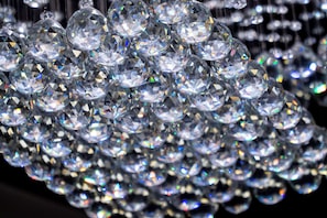 A close-up of multiple clear, faceted crystals arranged in a cluster.