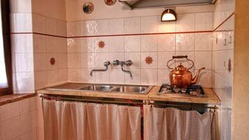 Fogão, cafeteira/chaleira, talheres/pratos/utensílios de cozinha