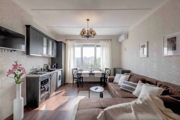 Bright and spacious living room with modern decor, offering the perfect spot to relax after a day exploring the city