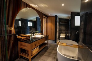 A modern bathroom with a large mirror, wooden vanity, dual sinks, and a freestanding bathtub. - Big Sun Residence by iRETREAT (Ko Yao)