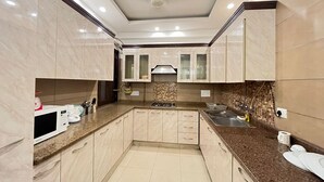 Una cocina moderna con encimeras de mármol, electrodomésticos de acero inoxidable y una isla central.