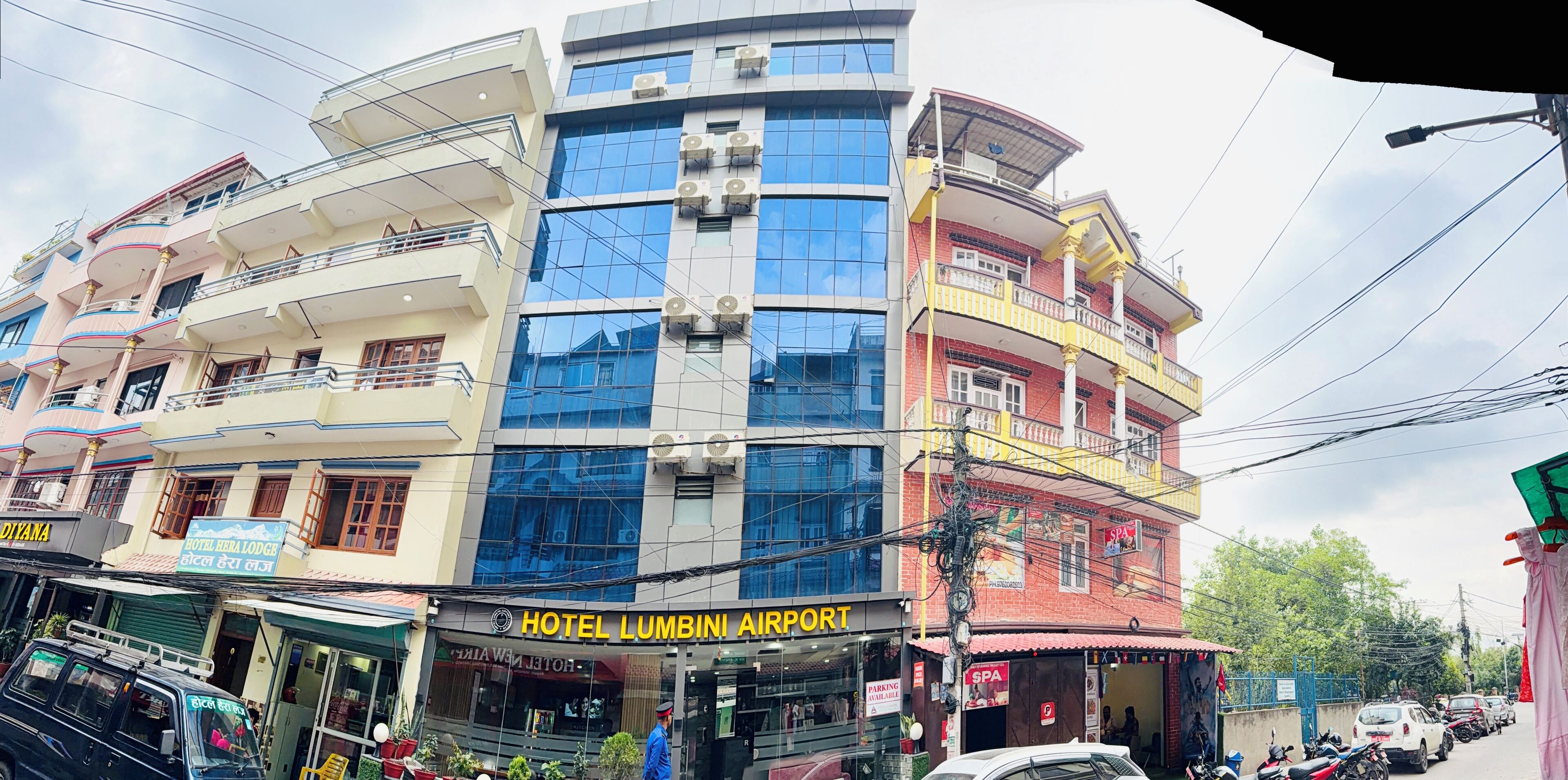 A multi-story building with a hotel named 'Hotel Lumbini Airport' on the ground floor.