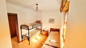 Cozy retreat with a bunk bed setup, bedside table, and framed picture.