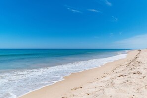 A beach with clear skies and calm waters.