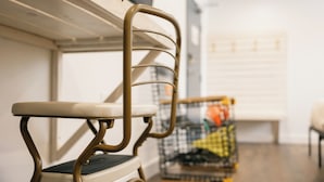 A bunk bed with a metal frame and a cushioned seat. - Homeport Suites & Residences (Lords Cove)