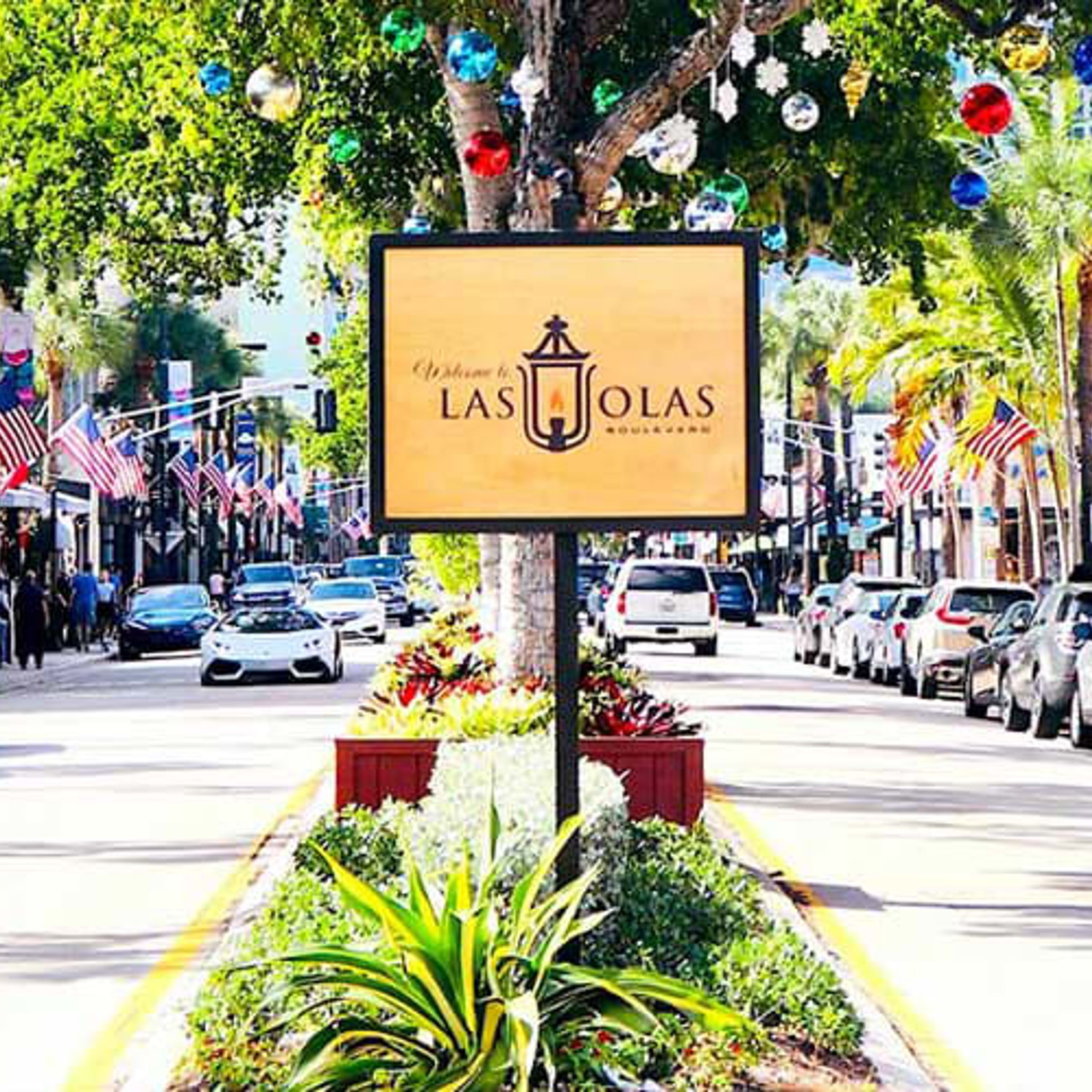 A street view with a sign for 'Las Olas' hotel.