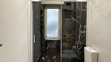 Een douche, een haardroger, een bidet, handdoeken