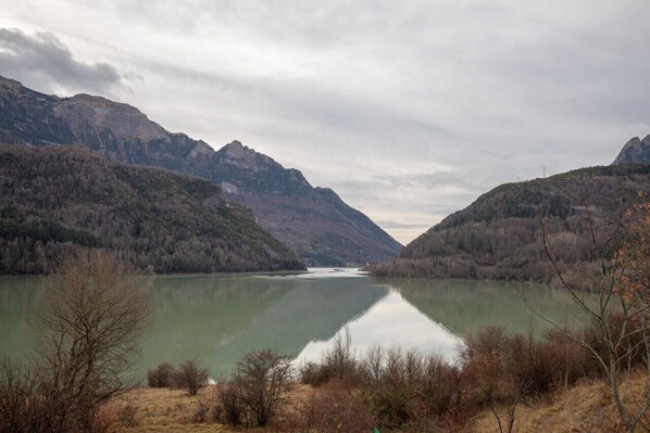 A calm lake surrounded by mountains.