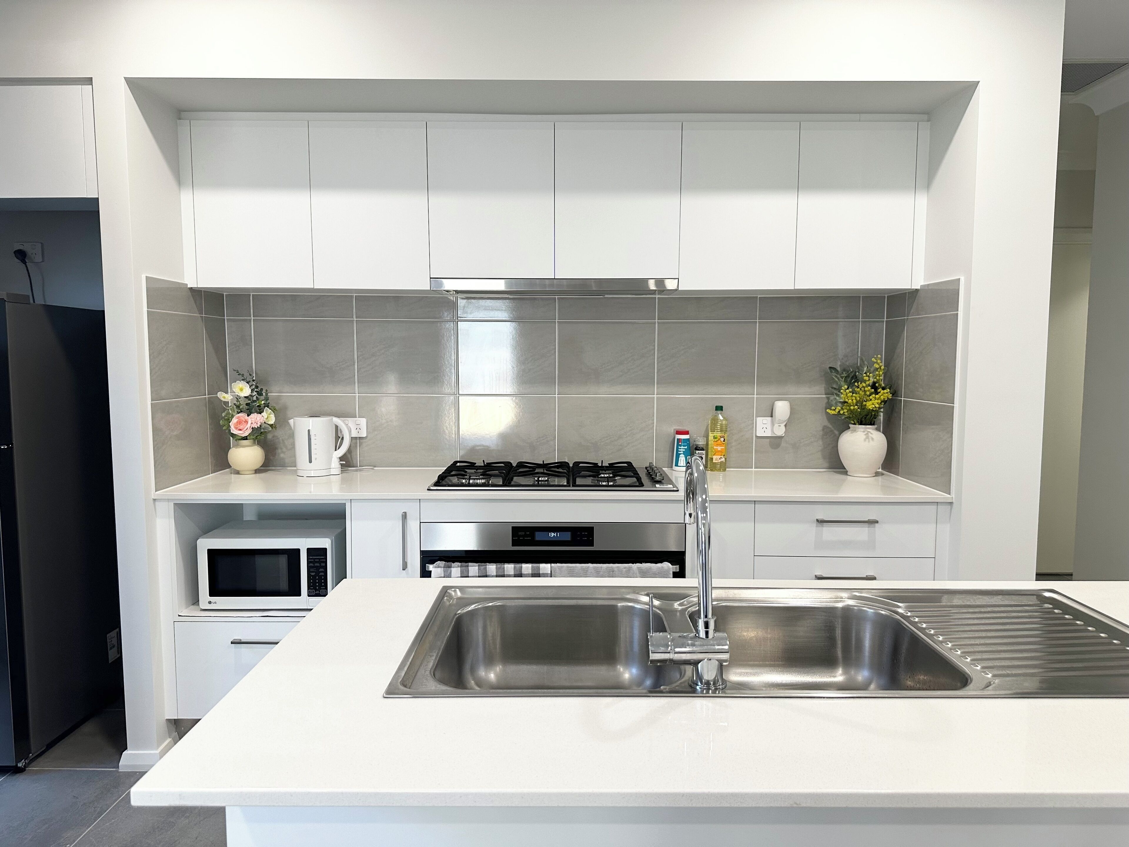 Fully equipped modern kitchen with stainless steel appliances.