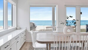 A dining area with a view of the ocean, white furniture, and a large window. - Viviana #12 | Luxury Gulf Front Home, Private Pool + Incredible Views! (Pensacola)