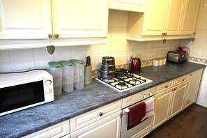Prepare meals in this well-equipped kitchen with a microwave, gas stove, and toaster.