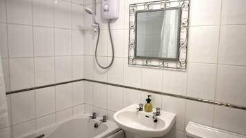 A bathroom with a bathtub, a sink, and a shower.