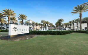 A sign for '30 Avenue' with a landscaped area featuring palm trees and a fountain. - Inlet Beach - Private Pool + Fenced Yard & Bikes (Inlet Beach)