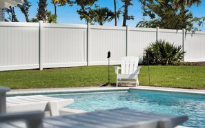 A swimming pool with a white deck, a white fence, and a white chair. - Inlet Beach - Private Pool + Fenced Yard & Bikes (Inlet Beach)