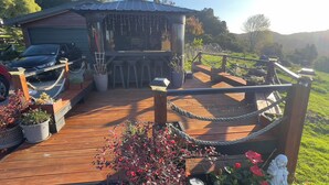 A wooden deck with a rope barrier, potted plants, and a small gazebo. - Mel’s Retreat - Private Room & Ensuite (Te Kuiti)