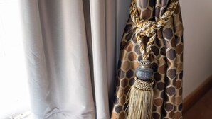 A curtain with a patterned design and a decorative tassel. - The Warehouse (Yeovil)
