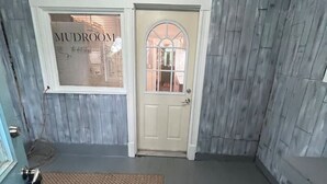 A room with a wooden floor, a beige door, a window with blinds, and a small rug. - Last Minute opening! Dog friendly place! Fenced yard! 3 bed!  (Superior)