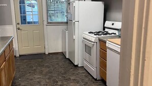 A compact kitchen with a refrigerator, stove, and dishwasher. - Last Minute opening! Dog friendly place! Fenced yard! 3 bed!  (Superior)