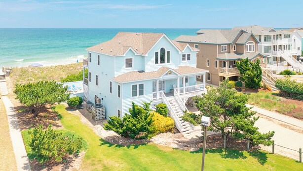 A coastal residential area with houses featuring balconies and a view of the ocean. - Beautiful oceanfront home in Duck with gorgeous views! (Duck)