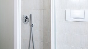 A shower with a handheld showerhead and a wall-mounted control panel. - 4bnb - Reale House Borgo (Rome)