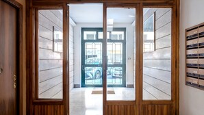A hallway with a wooden door leading to a garage.