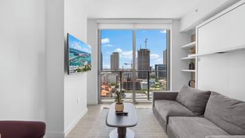 Deluxe Condo, Balcony, City View | Living area | 50-inch plasma TV with cable channels