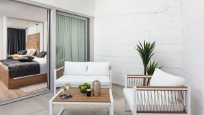 A modern hotel room with a bed, a sofa, a coffee table, and a potted plant. - Villa Dante Zadarvillas (Sukosan)
