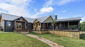 A log cabin-style building with a stone pathway leading to the entrance. - Main Cabin - The Hendo (Henderson)