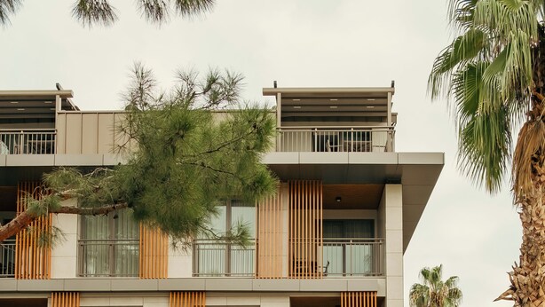 A modern building with balconies, large windows, and a sign for "BOMO suites & coffee". - Bomo Suites (Konyaalti)