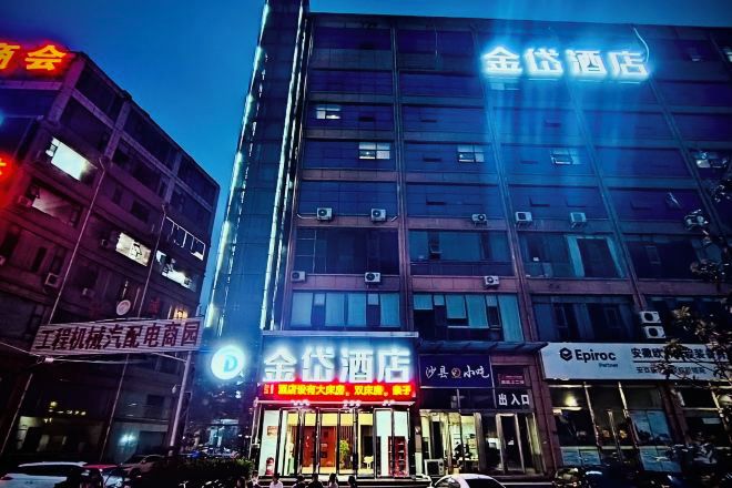 A hotel with multiple floors, large windows, and signage indicating it is a hotel.