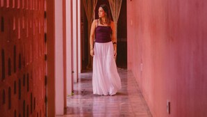 A corridor with a patterned wall, a doorway with a curtain, and a person in a white skirt and purple top. - Casa Amate 61 - Mérida Centro (Mérida)