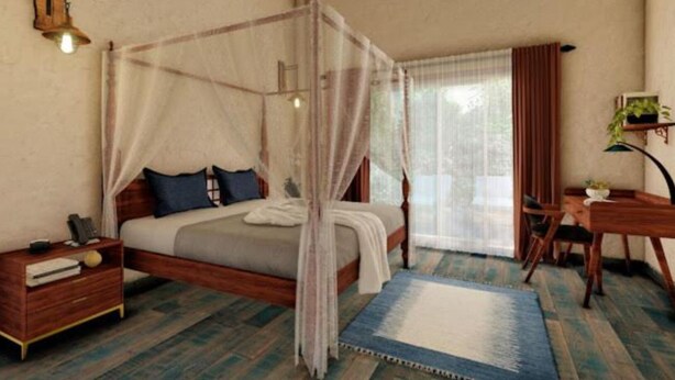 Un dormitorio con cama con dosel, una mesita de noche con lámpara, un escritorio con silla y una ventana con cortinas.