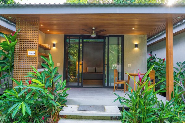 A modern building with a wooden ceiling, a ceiling fan, and a sign labeled 'Serenity.' - Serenity Bungalows Beach & Jungle Escape + AC (Puerto Viejo de Talamanca)