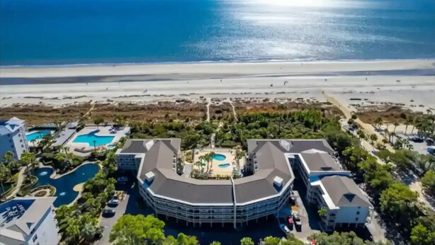 A resort with a central building, multiple swimming pools, and a beach view. - Coligny Beachfront Villa w/Pool at The Breakers (Hilton Head Island)