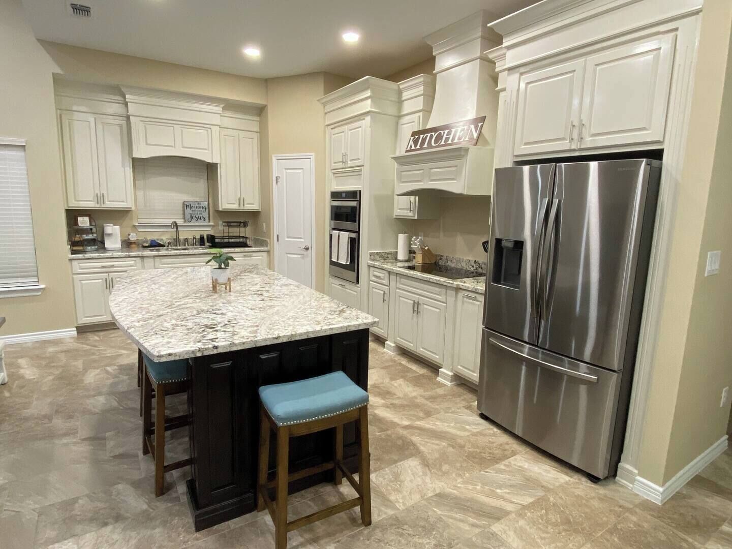 Well-equipped kitchen with stainless steel appliances and ample storage awaits. 