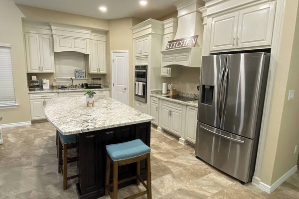 Well-equipped kitchen with stainless steel appliances and ample storage awaits.