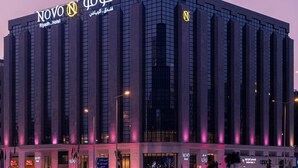 A modern hotel with a prominent 'Novo' sign, large windows, and a structured facade. - Novo Hotel (Riyadh)