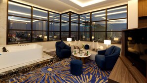 A modern hotel room with a large window, a bathtub, a sofa, and a round coffee table. - Novo Hotel (Riyadh)
