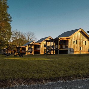 A wooden building with multiple levels and a covered porch area.