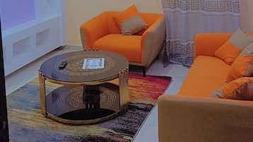 Family Studio, City View | Living area | Flat-screen TV